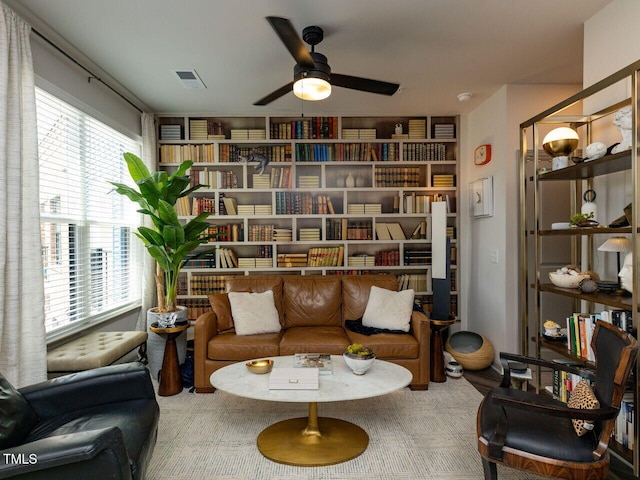 living area with a ceiling fan