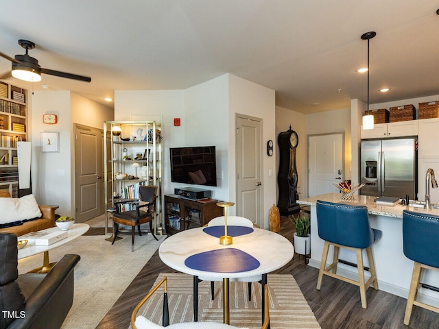 living room with ceiling fan and recessed lighting