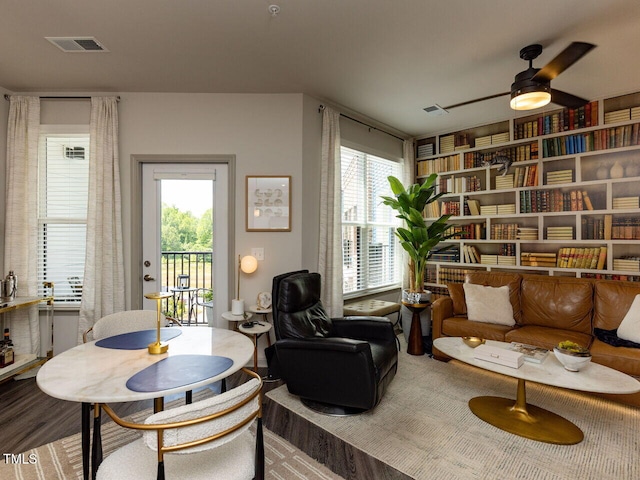 living area featuring wood finished floors and ceiling fan