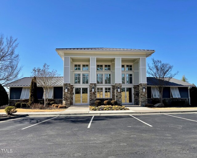 view of building exterior with uncovered parking