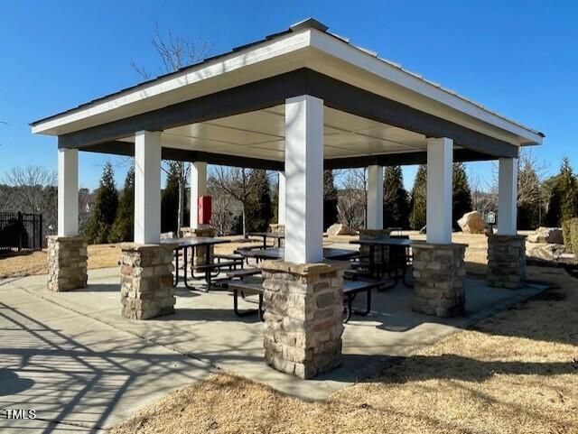 view of home's community with a gazebo, outdoor dining area, and a patio