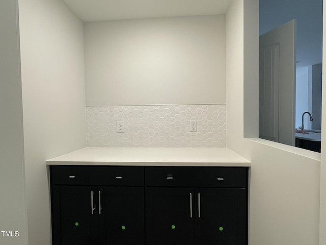 interior space with tasteful backsplash and a sink