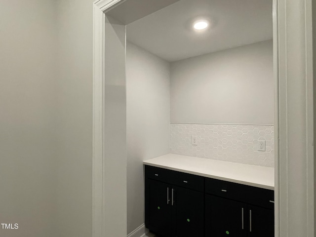 bathroom with vanity and tasteful backsplash