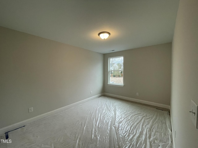 spare room featuring baseboards