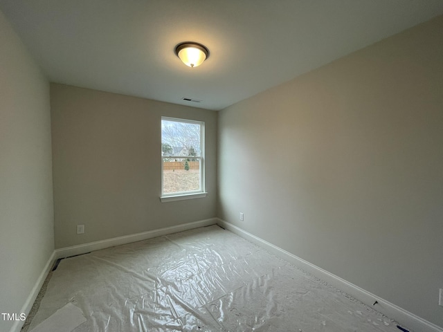 empty room with baseboards and visible vents