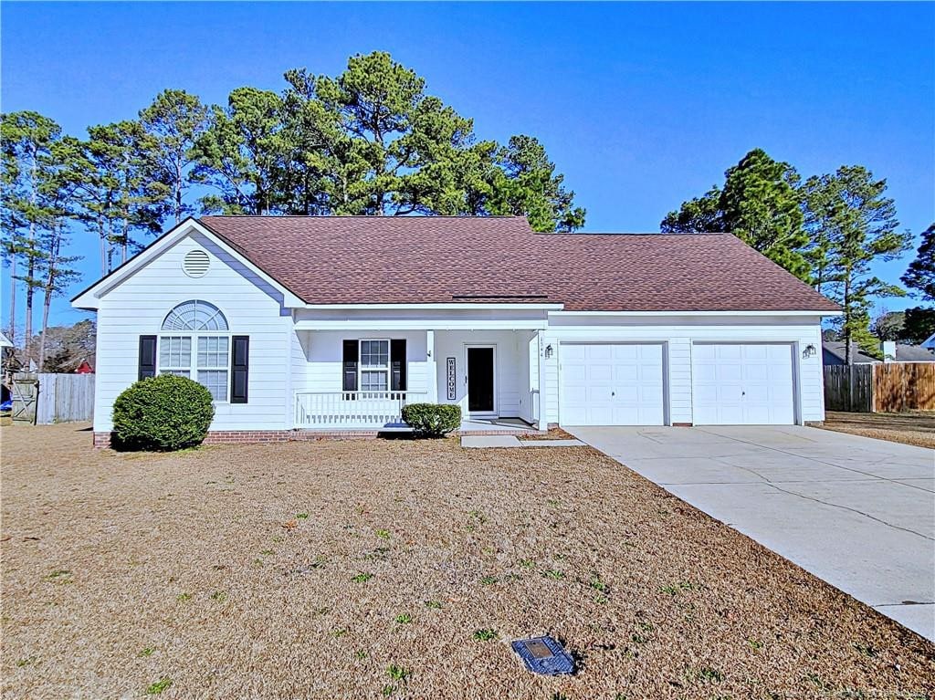 ranch-style home featuring a garage and covered porch