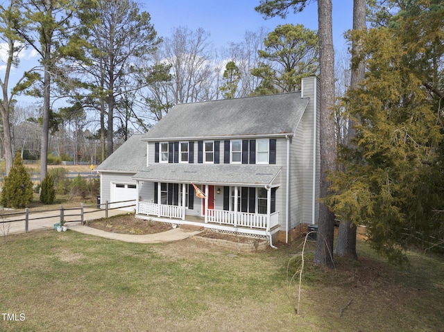 colonial home featuring a porch and a front yard