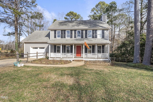 colonial-style house featuring a porch, a garage, and a front yard