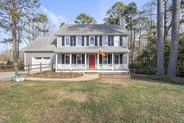 colonial house featuring a porch, a garage, and a front lawn