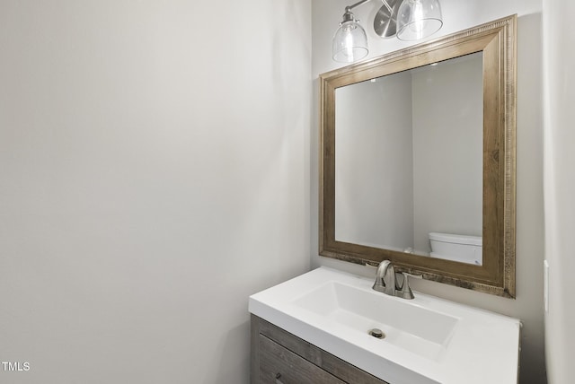 bathroom featuring vanity and toilet