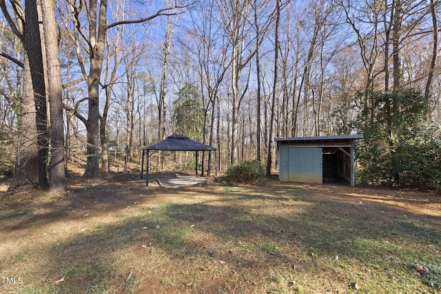 view of yard featuring a gazebo and an outbuilding