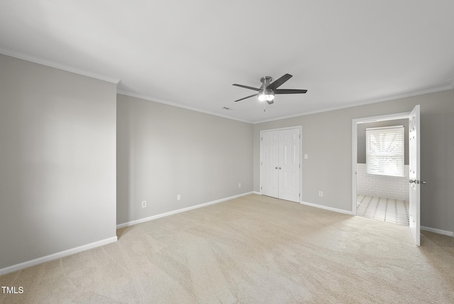 carpeted empty room featuring crown molding and ceiling fan