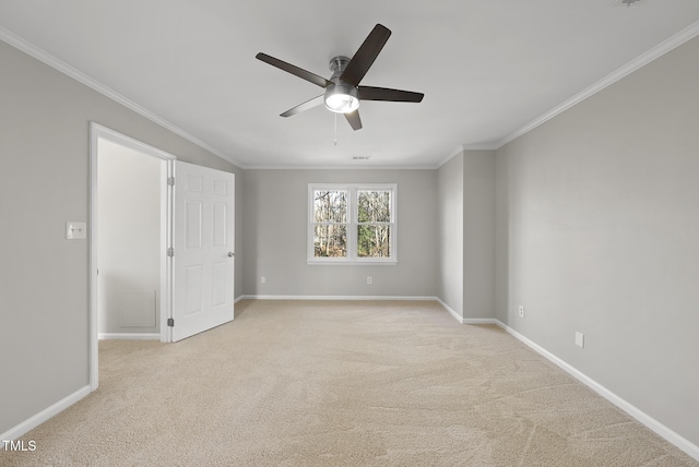 carpeted empty room with ornamental molding and ceiling fan