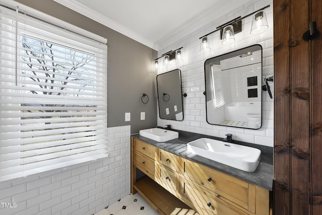 bathroom featuring crown molding, vanity, and tile walls