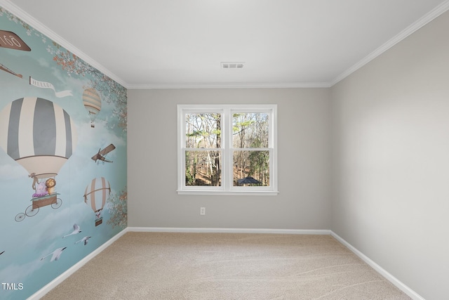 empty room featuring crown molding and carpet floors