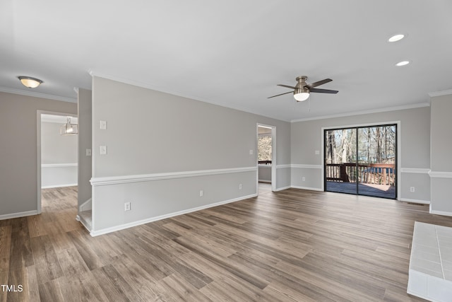 unfurnished living room featuring wood-type flooring, ornamental molding, and ceiling fan