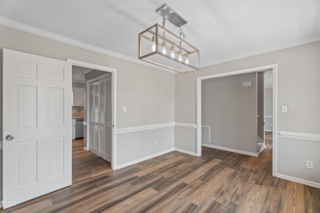 unfurnished dining area featuring ornamental molding and dark hardwood / wood-style flooring