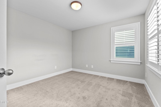 unfurnished room with light colored carpet