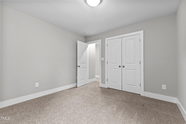 unfurnished bedroom featuring carpet and a closet