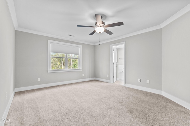 carpeted empty room featuring ceiling fan and crown molding