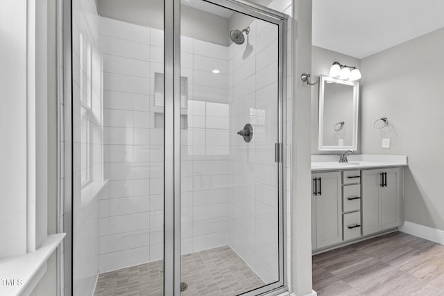 bathroom with walk in shower and vanity