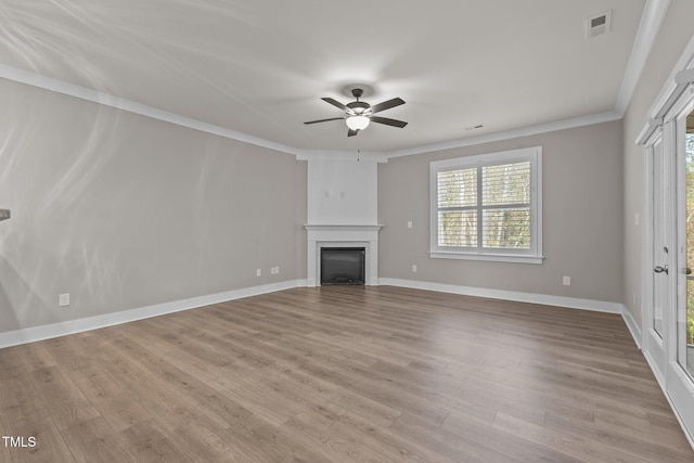 unfurnished living room with ceiling fan, ornamental molding, and light hardwood / wood-style flooring