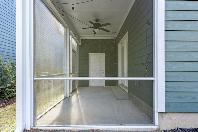 unfurnished sunroom with ceiling fan