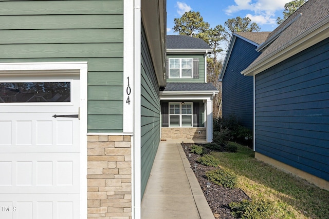 doorway to property with a garage