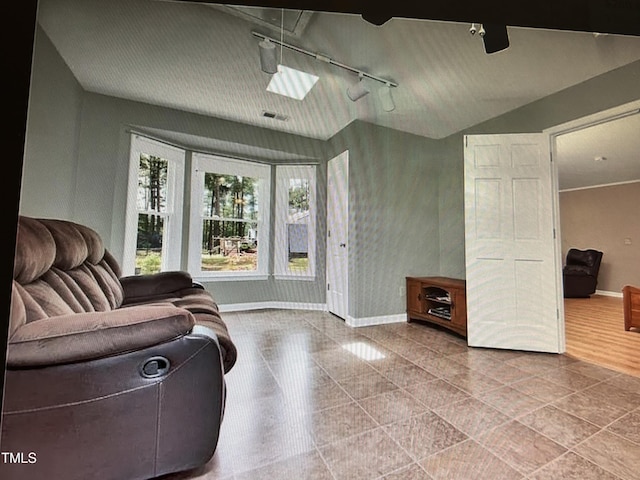 living room with baseboards and vaulted ceiling