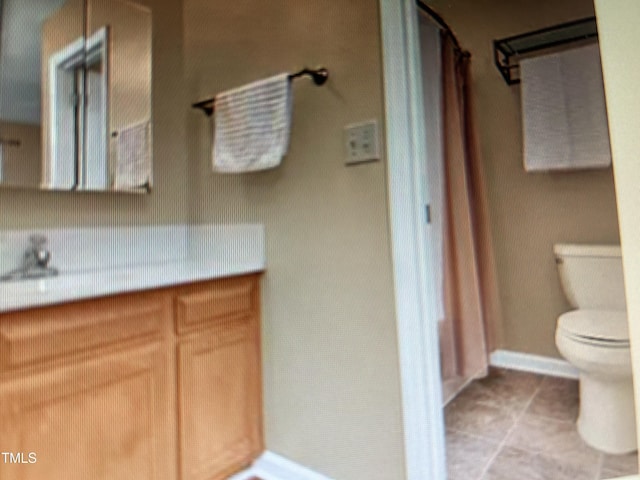 bathroom featuring baseboards, toilet, tile patterned floors, curtained shower, and vanity