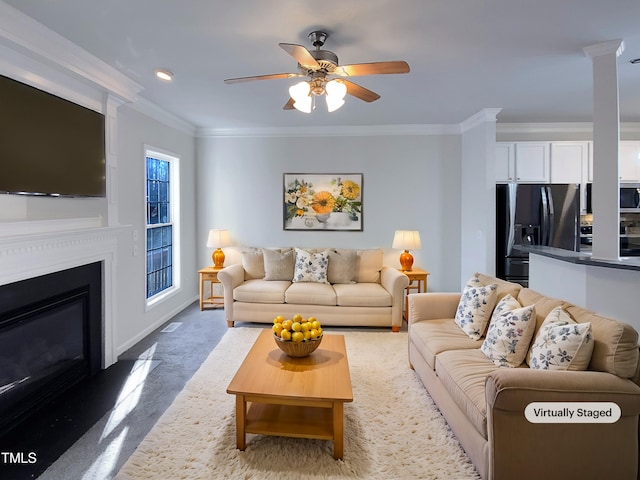 living room featuring ceiling fan, ornamental molding, and carpet flooring