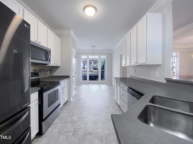 kitchen featuring sink, white cabinetry, appliances with stainless steel finishes, and crown molding