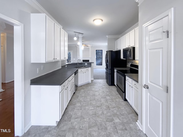 kitchen featuring white cabinets, decorative light fixtures, stainless steel appliances, sink, and ornamental molding