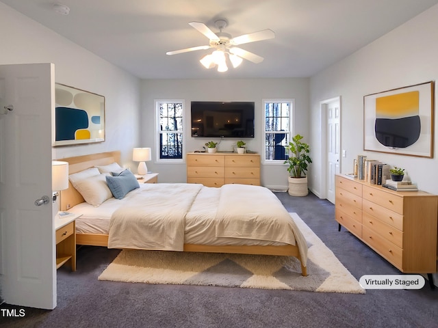 bedroom with ceiling fan and dark colored carpet