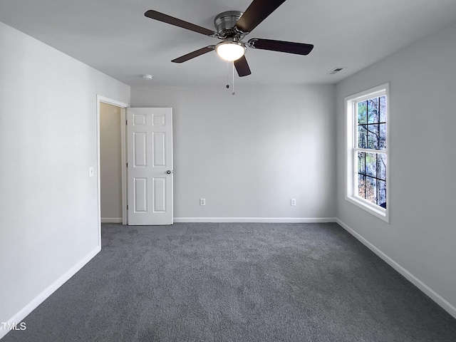 carpeted spare room with ceiling fan