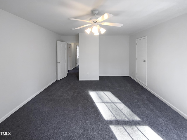 unfurnished room featuring ceiling fan and dark colored carpet