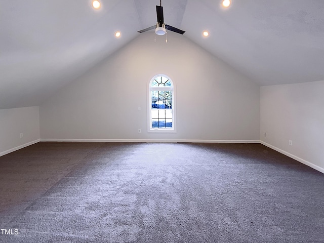 additional living space featuring ceiling fan, vaulted ceiling, and dark carpet