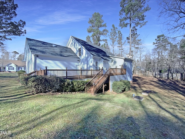 rear view of house with a lawn and a deck