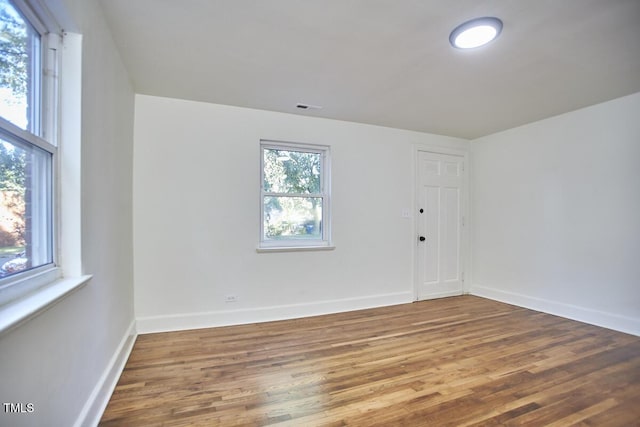 unfurnished room featuring hardwood / wood-style flooring