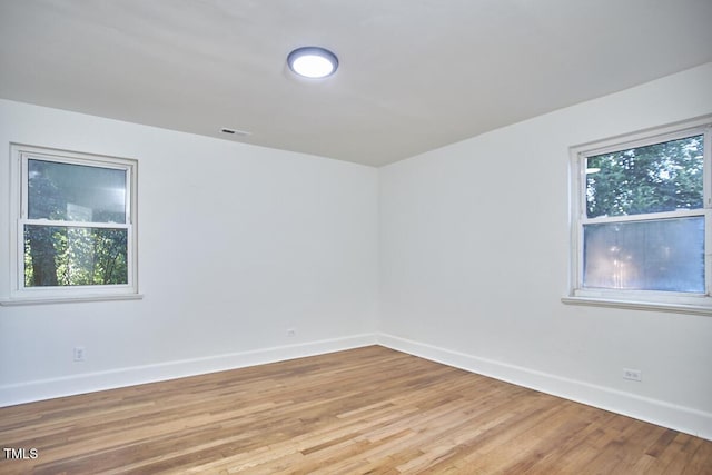 empty room with plenty of natural light and light wood-type flooring