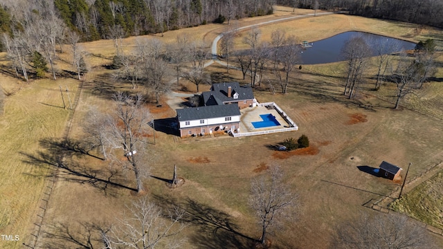 birds eye view of property featuring a water view and a rural view