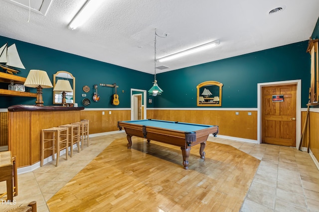 recreation room featuring pool table, a textured ceiling, and light tile patterned floors