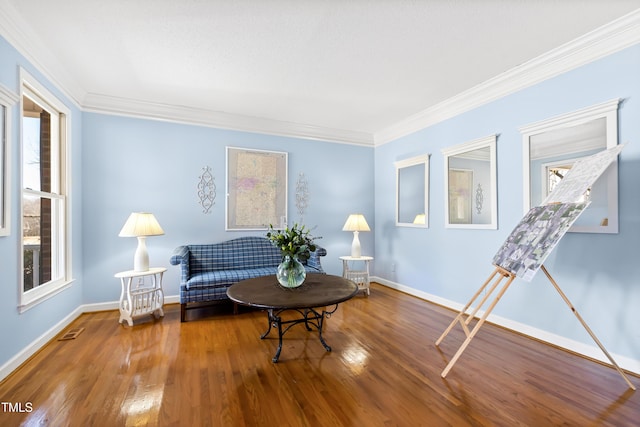 living area featuring crown molding and hardwood / wood-style floors