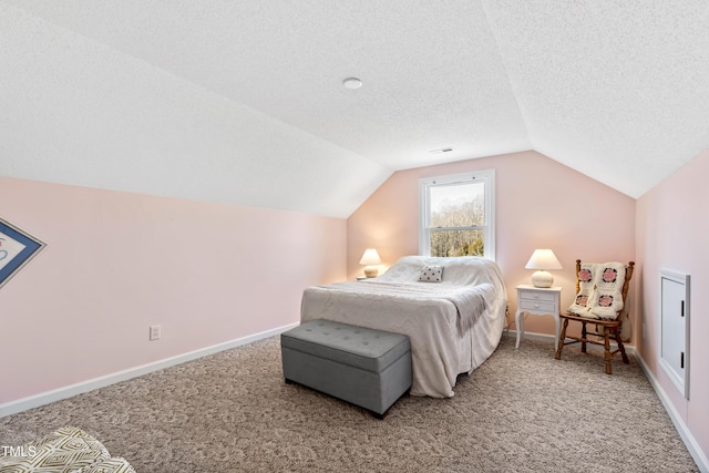 bedroom featuring lofted ceiling, carpet flooring, and a textured ceiling