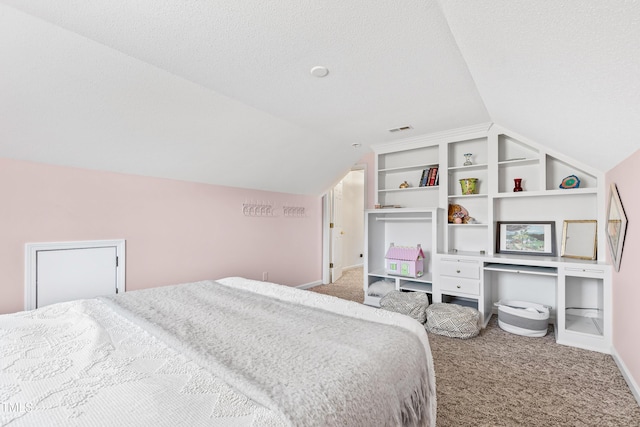 bedroom featuring lofted ceiling, a textured ceiling, and carpet flooring