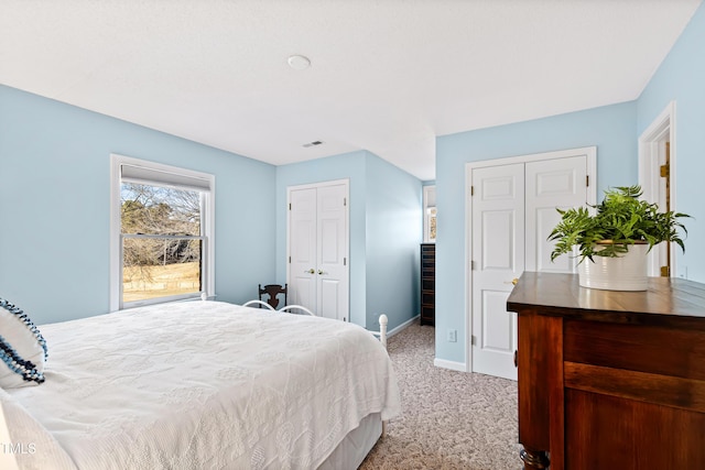 bedroom with light colored carpet