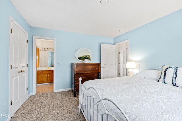 carpeted bedroom featuring ensuite bath