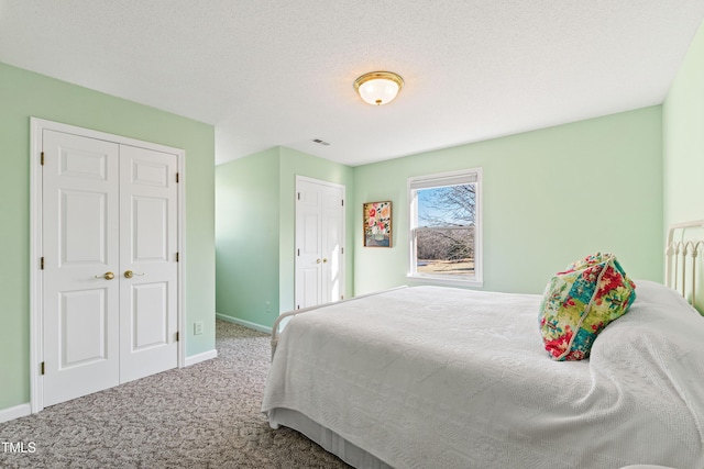 bedroom with a textured ceiling and carpet