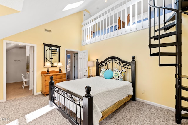 bedroom featuring light colored carpet and lofted ceiling with skylight