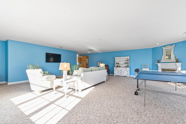 carpeted living room featuring a fireplace